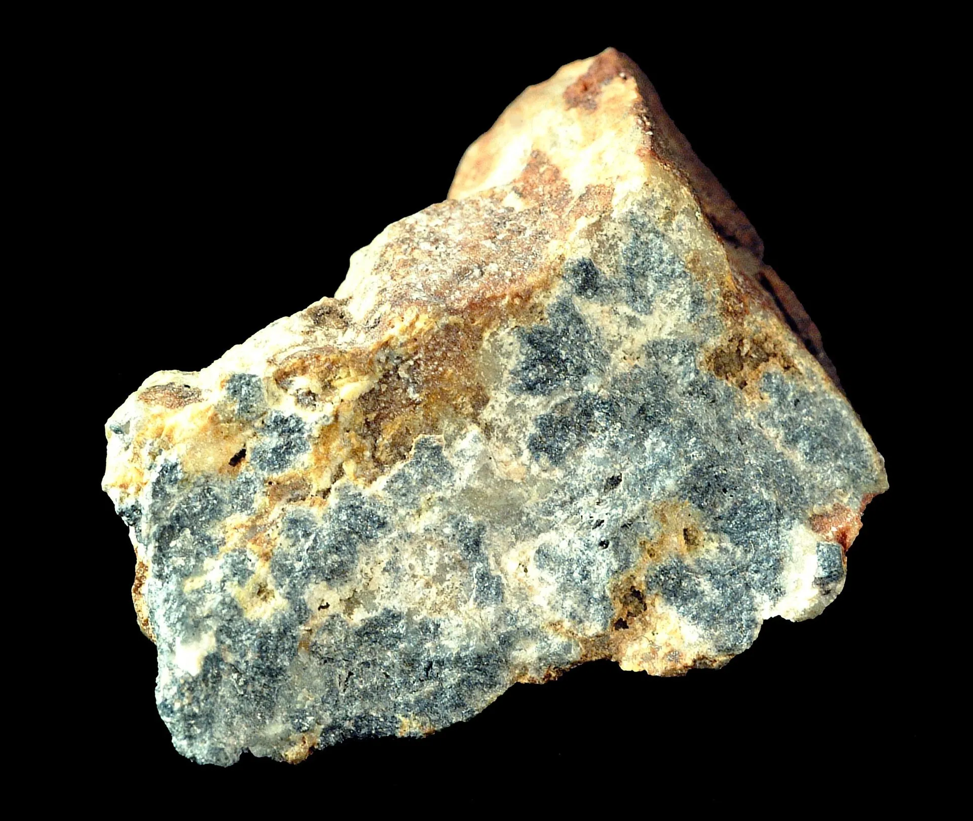 Chunk of silvery antimony ore photographed on a black background