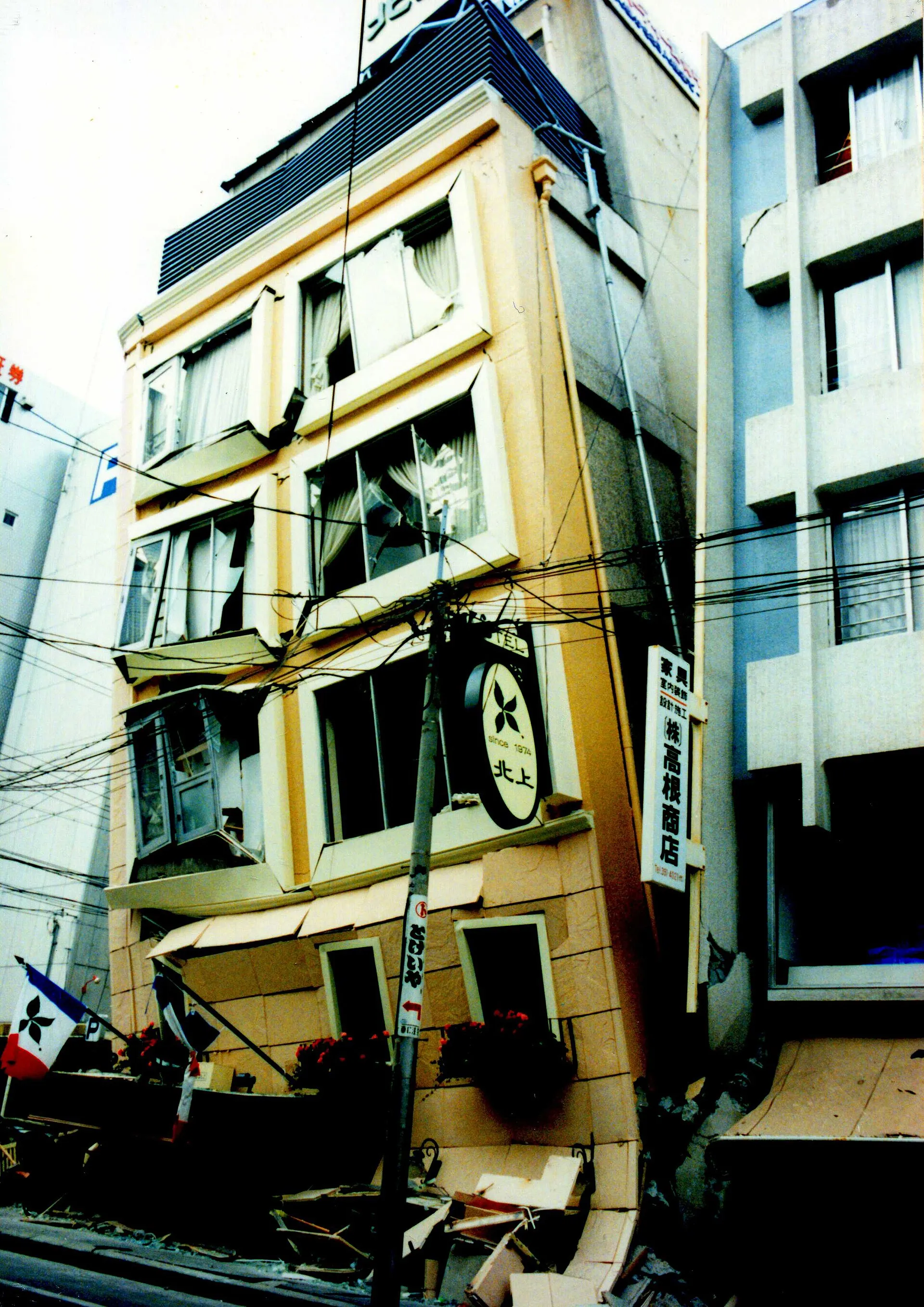 Building tilted onto the street after the 1995 Kobe earthquake