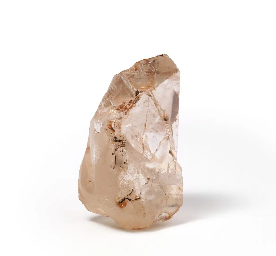 Rough uncut diamond crystal on a white background
