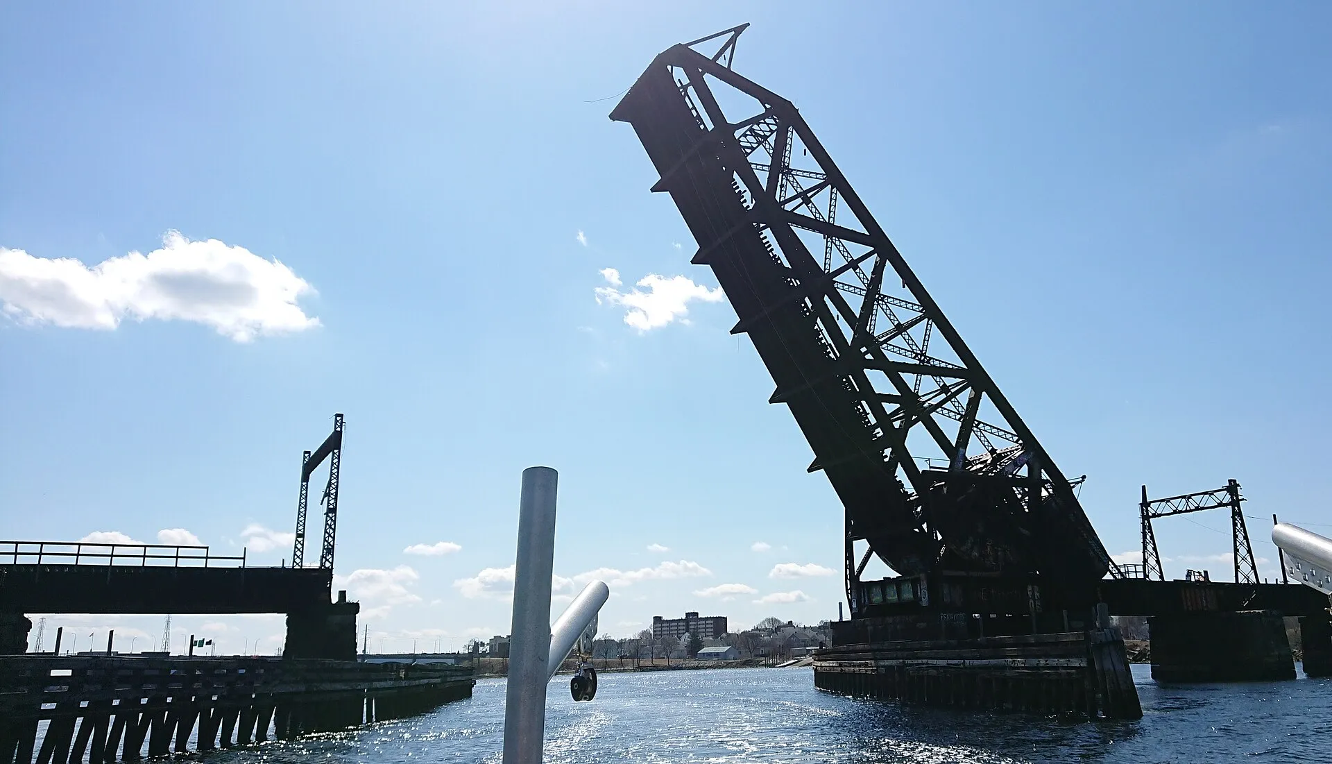 Steel bascule railroad bridge raised open over a waterway