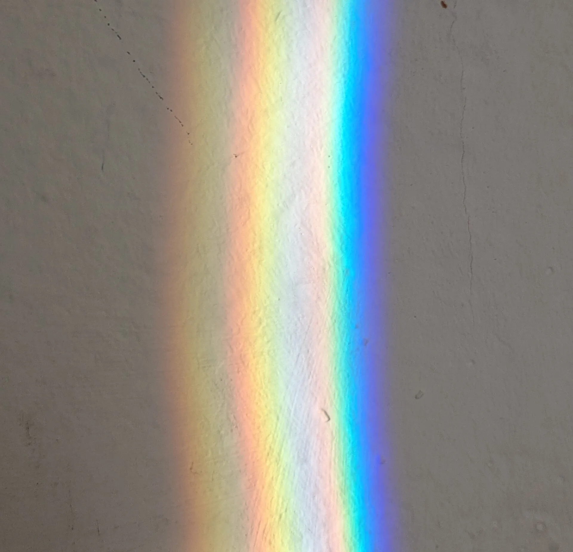 Bright band of rainbow colors spread by a glass prism