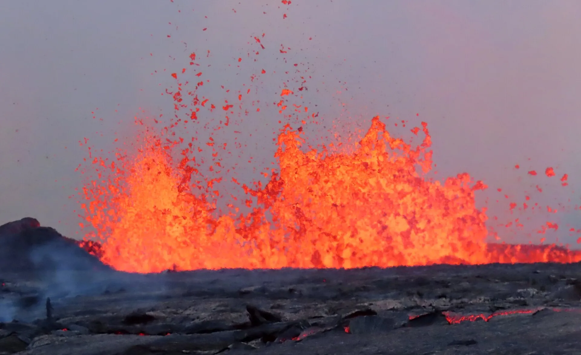 Fountains of red lava erupting during a volcanic outburst