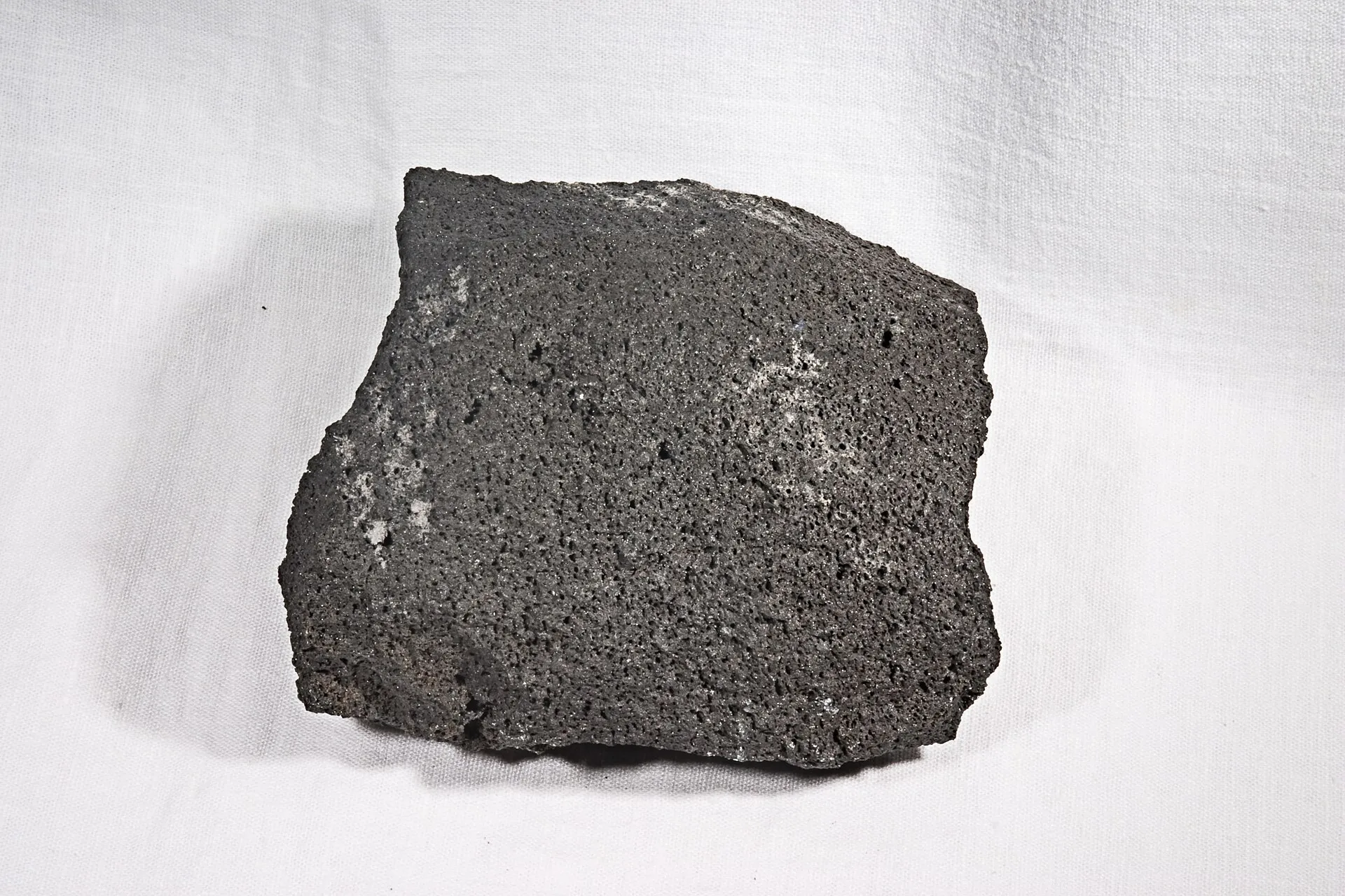 Grey andesite rock specimen with fine-grained volcanic texture