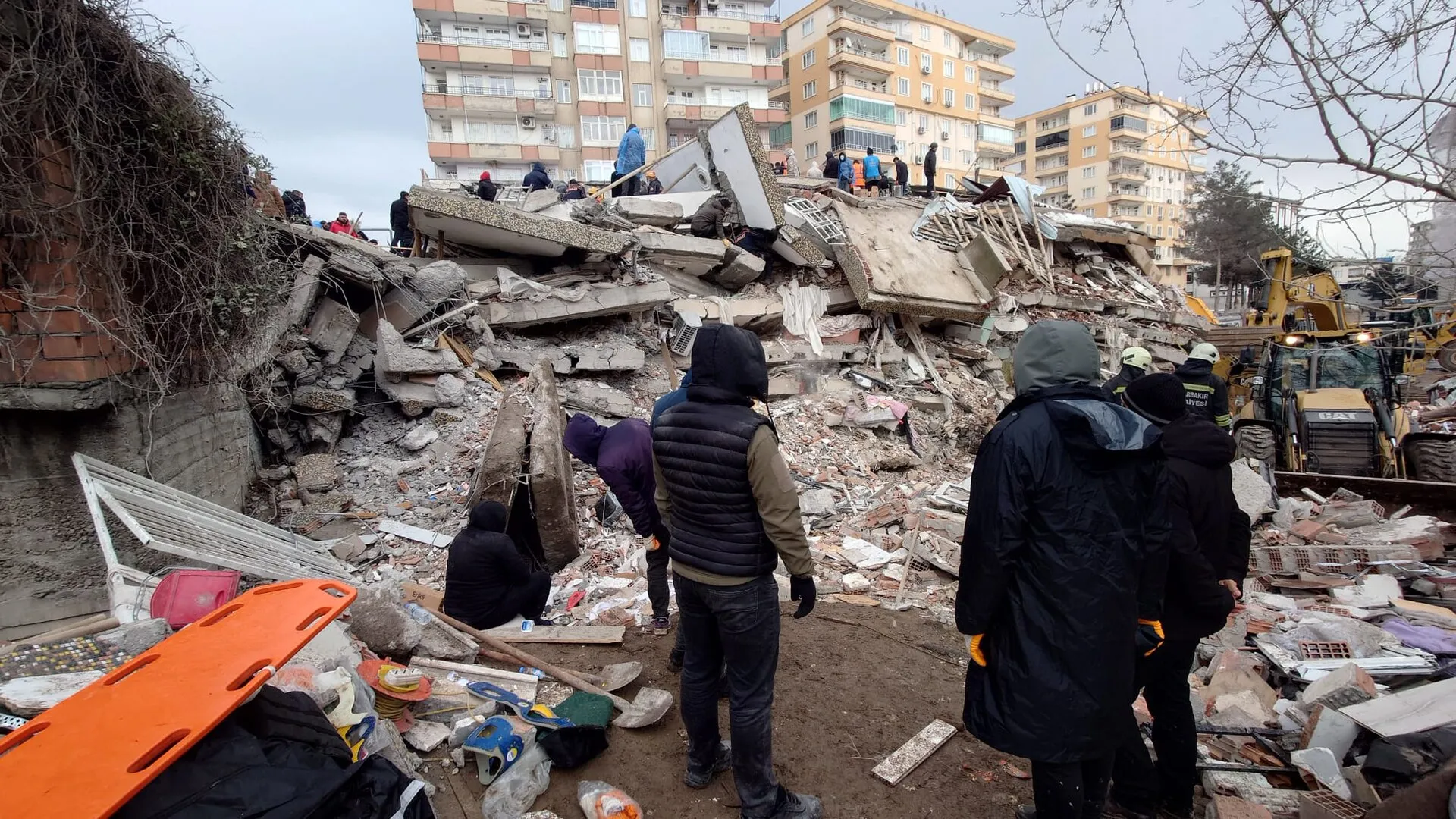 Rescue workers searching the rubble of a collapsed building after an earthquake